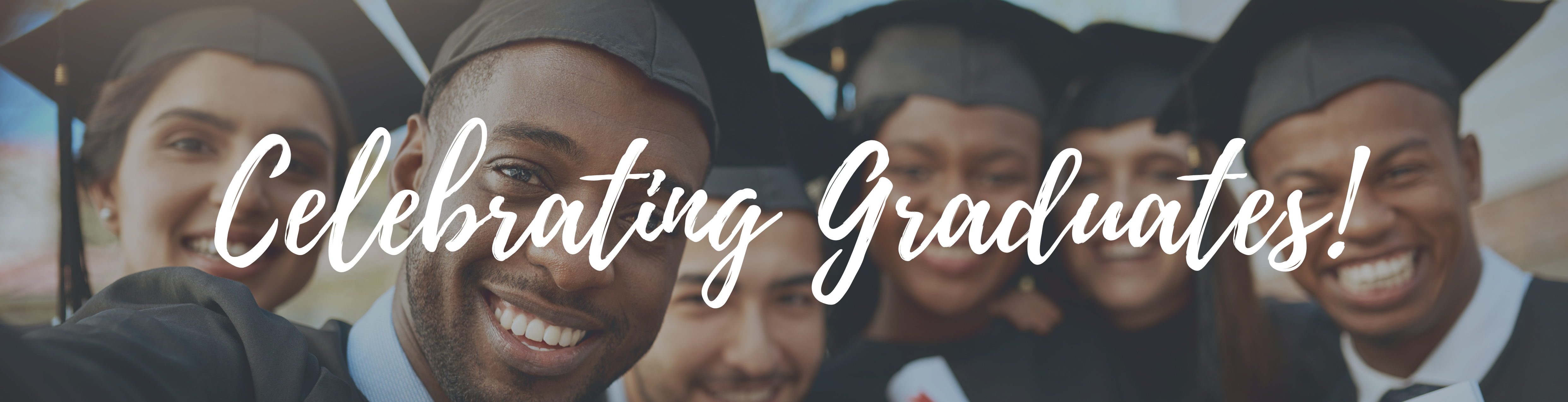 celebrating graduates with students wearing caps and gowns, smiling