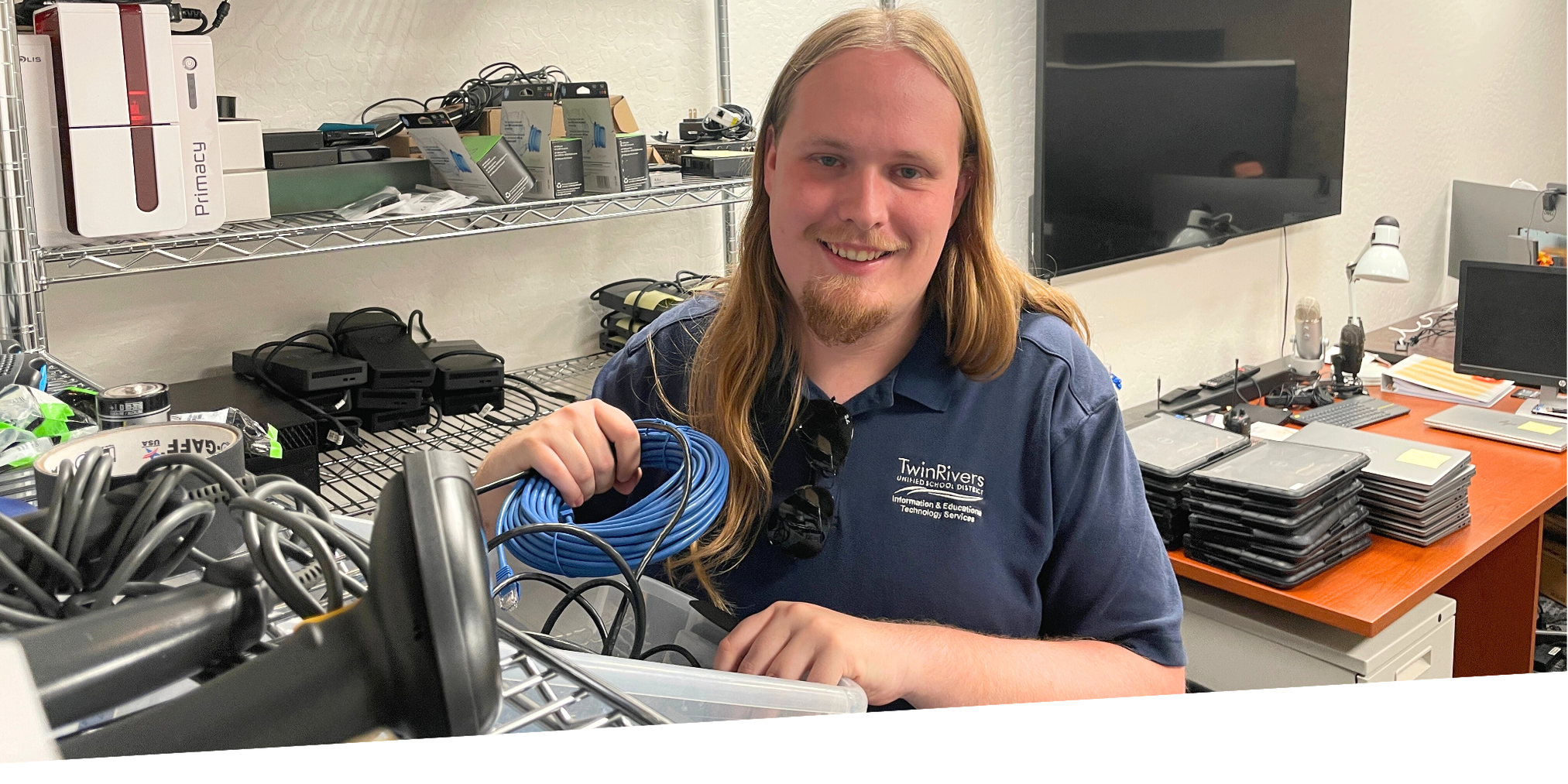 man smiling holding ethernet cable