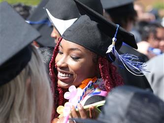 high school graduate hugging family member.