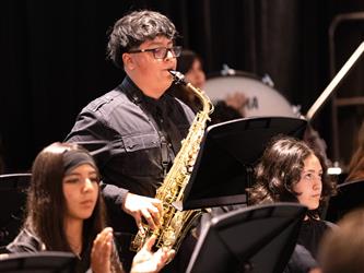 high school student playing a saxaphone