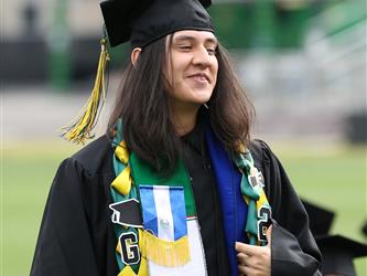 High school graduate smiling.