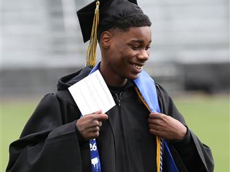High school graduate smiling.