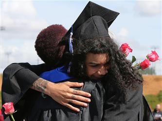 high school student hugging staff member.