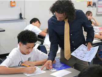 teacher helping student with assignment