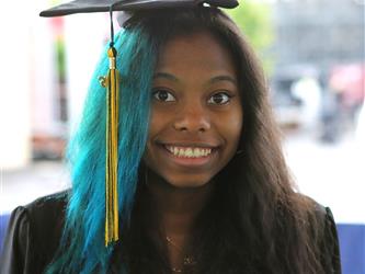 High school graduate smiling.