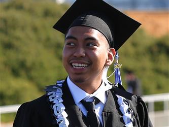 high school graduate smiling.