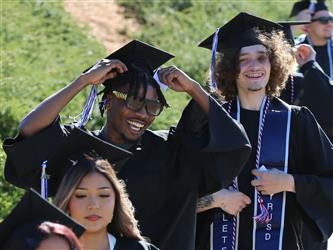 two high school students smiling and posing for camera.