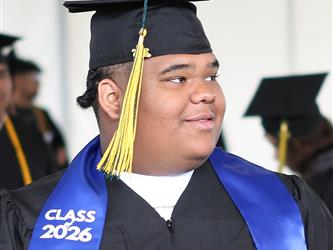 High school graduate smiling.