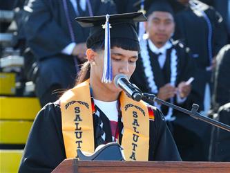 high school graduate giving a speech.