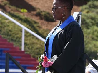high school staff member getting ready to hand out roses to graduating seniors.
