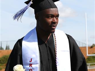 high school student holding a rose.
