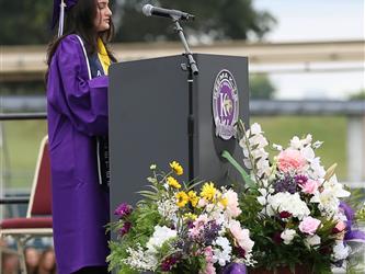 high school graduate giving speech.