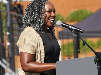 Adult Education principal giving speech at graduation ceremony.