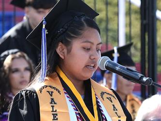 high school graduate giving a speech.