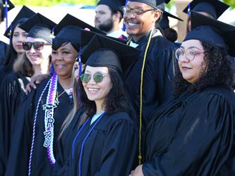 Adult Education graduates smiling brightly.