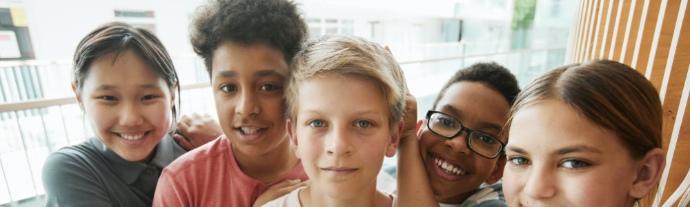 5 elementary students smiling