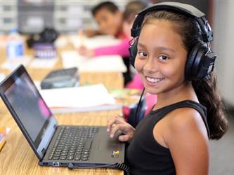 girl with headphones and laptop