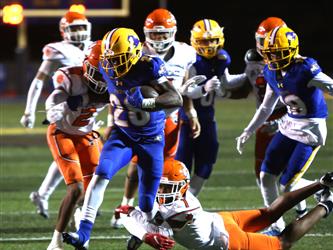 football players on field running and tackeling