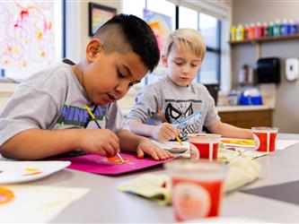 elementary student working on assignment at desk