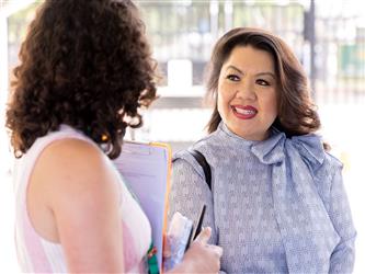 Dr. Tu Moua-Carroz talking with staff member