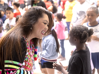 dr. carroz talking with young elementary student