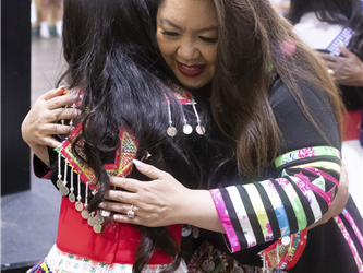 dr. carroz hugging elementary student