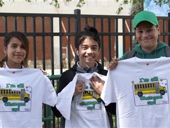 Students Holding EV bus Tshirt