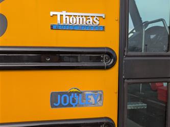 Side of EV School bus name and branding Type C Thomas 