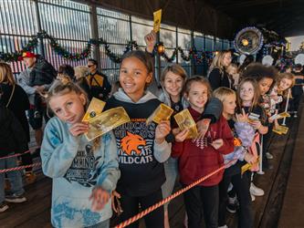 Westside after school program students falling in line before getting on the polar express