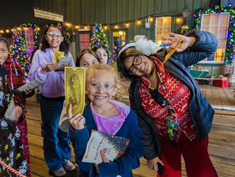 December 2025 - Students taking a group photo while forming a line to get in to the Polar Express