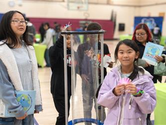 Students engaging in a science project presentation