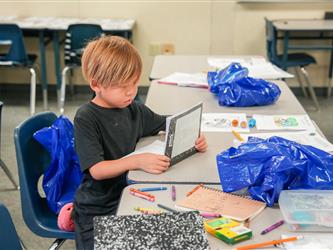 HYPU student looking at notebook
