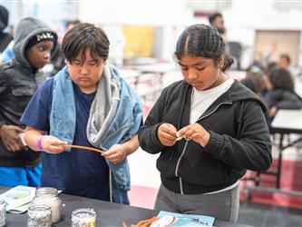 Students participating in a science exhibit