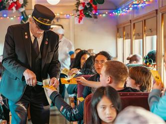 Westside after school program students with Polar Express conductor