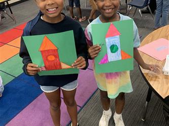 Two students showcasing their work