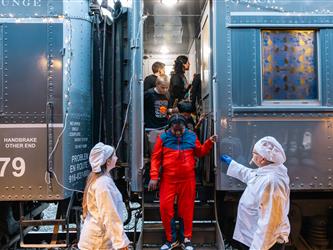 Westside after school program students getting off the Polar Express